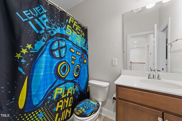 bathroom with curtained shower, vanity, toilet, and baseboards