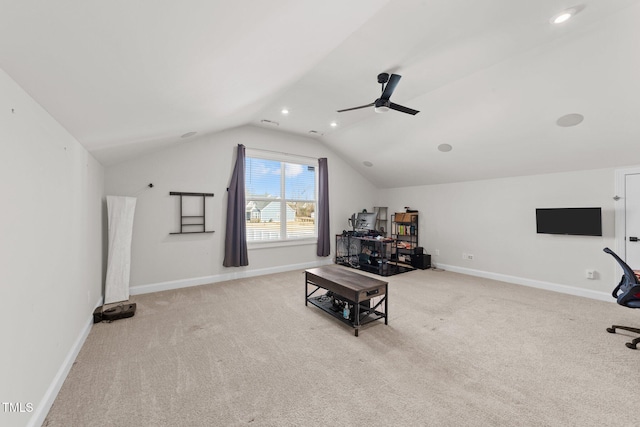 interior space with ceiling fan, carpet, baseboards, and vaulted ceiling