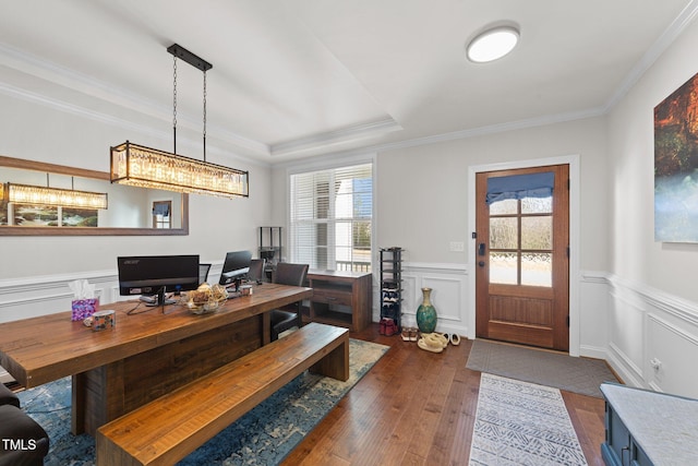 home office featuring plenty of natural light, wood-type flooring, and crown molding