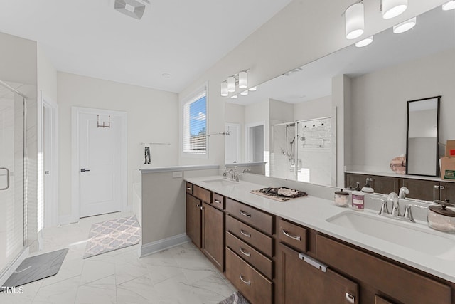 bathroom featuring marble finish floor, a shower stall, visible vents, and a sink