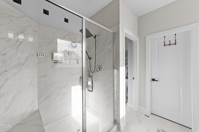 full bathroom with marble finish floor, visible vents, and a marble finish shower