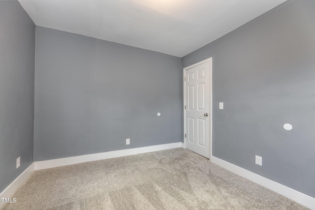 spare room featuring light colored carpet