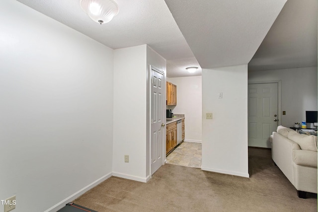 interior space with light colored carpet and a textured ceiling