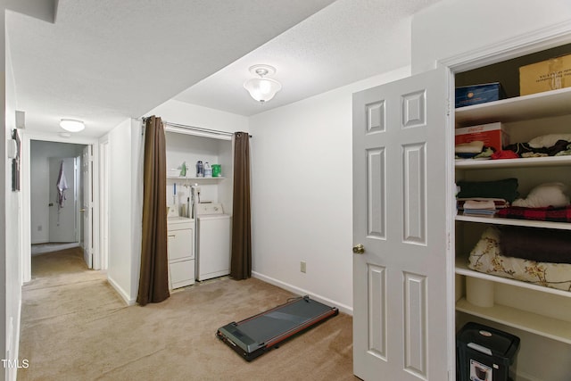 workout room featuring light colored carpet and independent washer and dryer