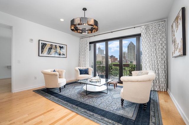 living area with a chandelier and hardwood / wood-style floors