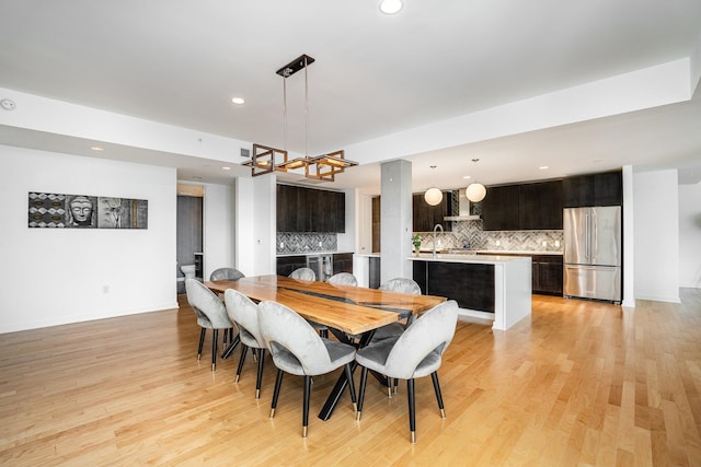 dining space featuring light hardwood / wood-style flooring and sink