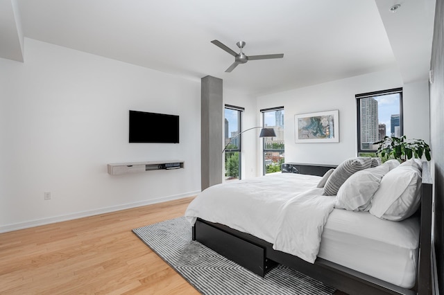 bedroom with ceiling fan and hardwood / wood-style flooring