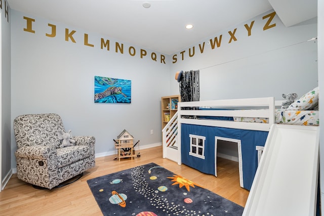 bedroom with hardwood / wood-style floors