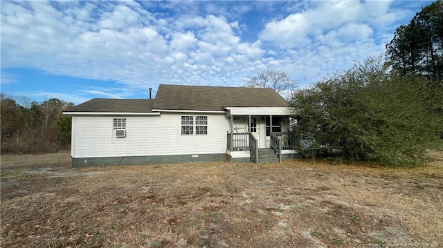 rear view of property with cooling unit