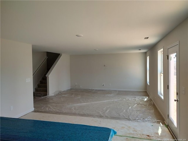 interior space with baseboards and stairway