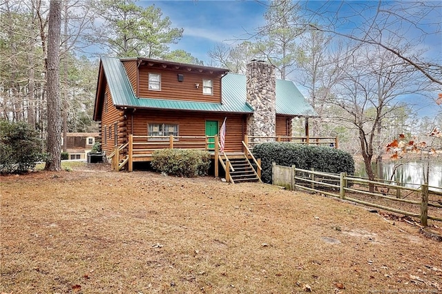 view of front of house featuring a deck with water view