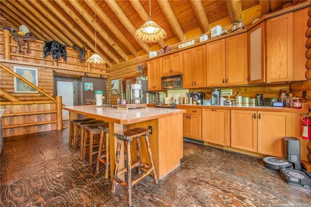 329 Silver Grove Church Rd, Rockingham, NC 28379 - kitchen with tile counters, stainless steel microwave, high vaulted ceiling, wooden ceiling with exposed beams, and a kitchen island with sink