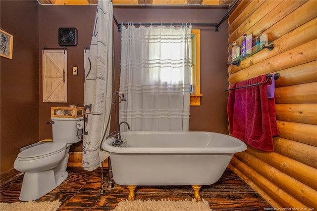 329 Silver Grove Church Rd, Rockingham, NC 28379 - bathroom featuring rustic walls, toilet, and a freestanding bath