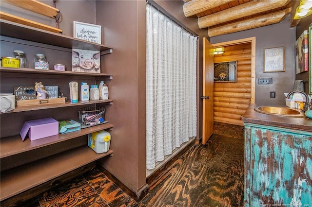 329 Silver Grove Church Rd, Rockingham, NC 28379 - bathroom featuring rustic walls, vanity, beamed ceiling, baseboards, and wood finished floors
