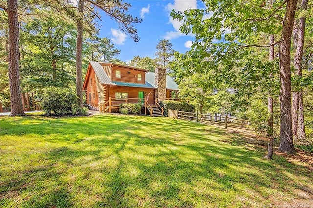 329 Silver Grove Church Rd, Rockingham, NC 28379 - rear view of house with log siding, a chimney, and stairway