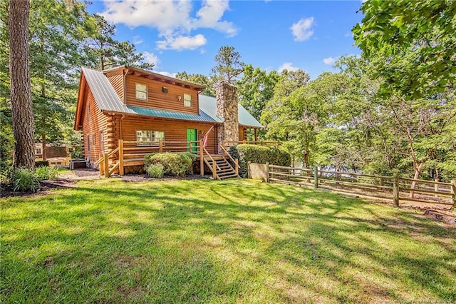 329 Silver Grove Church Rd, Rockingham, NC 28379 - back of house featuring a chimney, log exterior, and metal roof