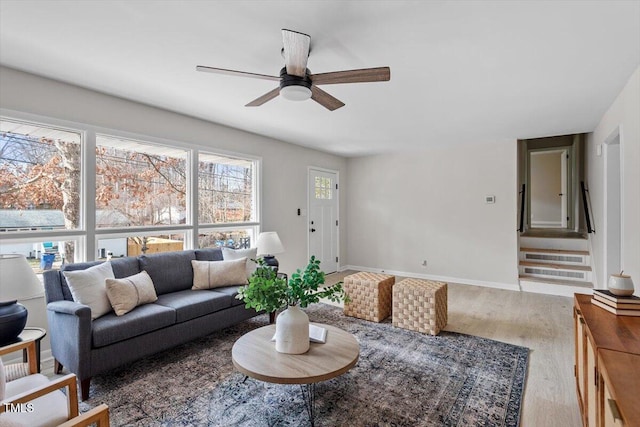 living room featuring hardwood / wood-style flooring, ceiling fan, and a wall mounted air conditioner