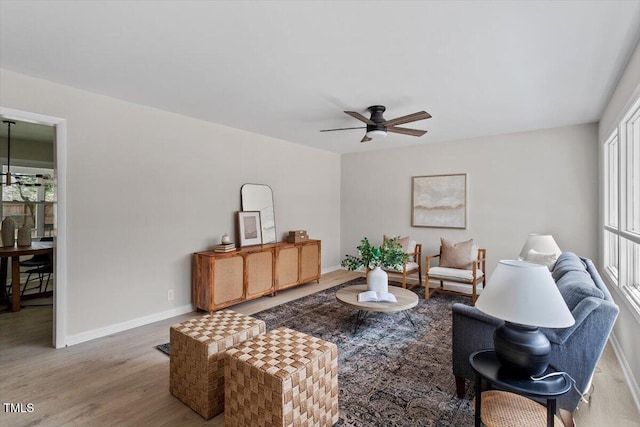 living room featuring hardwood / wood-style flooring and ceiling fan