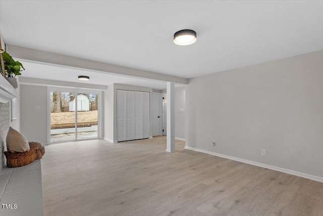 interior space with a fireplace and light hardwood / wood-style floors