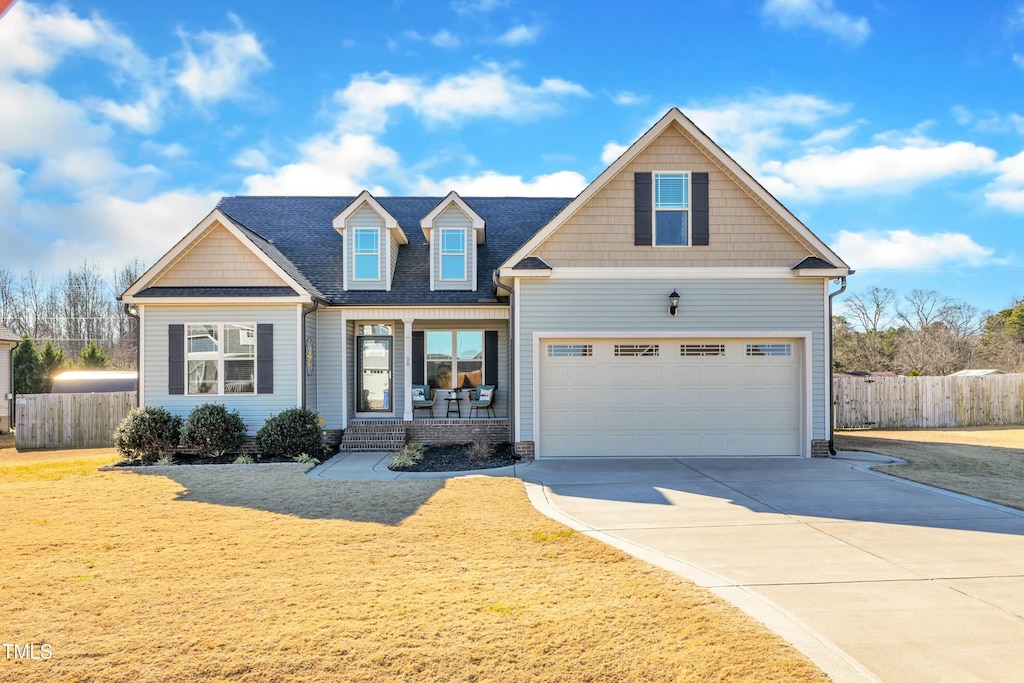 view of front of property featuring a porch and a garage