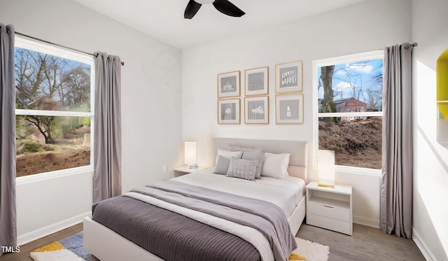 bedroom with wood-type flooring and ceiling fan