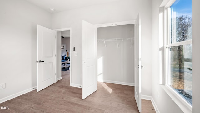 unfurnished bedroom featuring light wood-type flooring and a closet