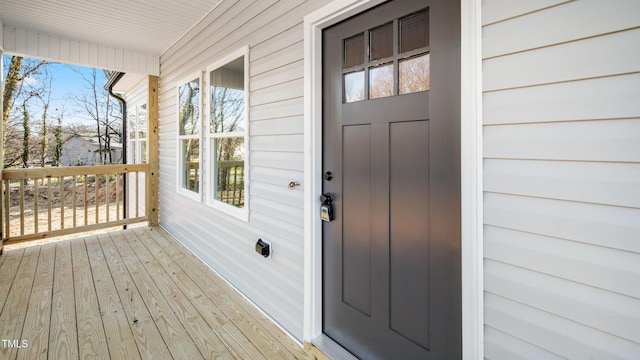 view of exterior entry with a porch