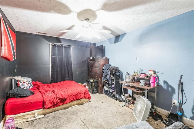 carpeted bedroom featuring ceiling fan and a textured ceiling