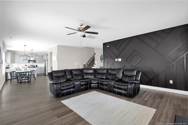 living room featuring ceiling fan and dark wood-type flooring