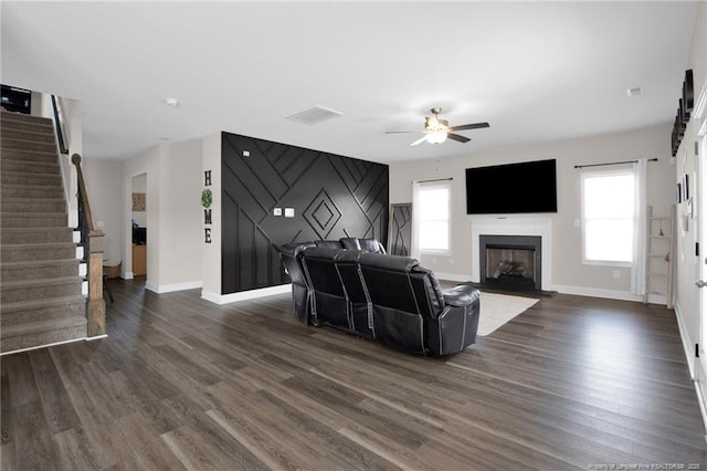 living room featuring ceiling fan and dark hardwood / wood-style flooring