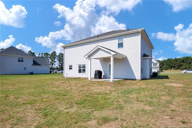 rear view of property with a lawn and a patio area