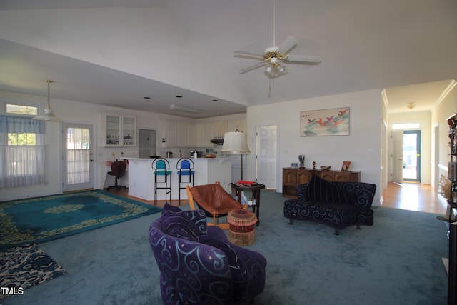 living area featuring a ceiling fan, carpet, high vaulted ceiling, and a wealth of natural light