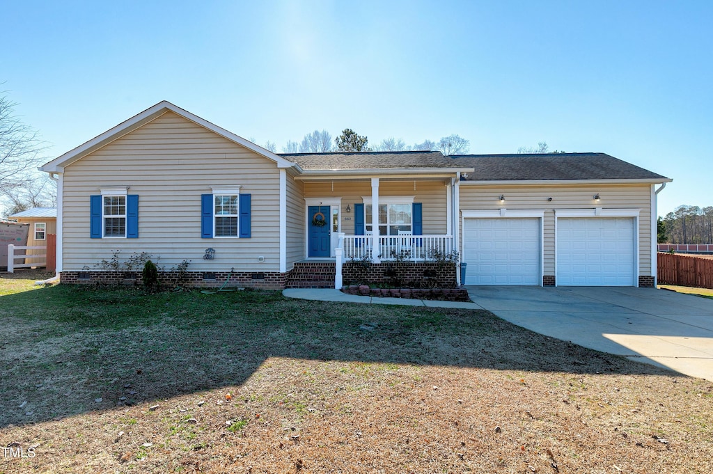 ranch-style home featuring a front yard, a porch, and a garage