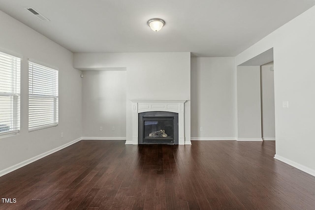 unfurnished living room with dark wood-type flooring