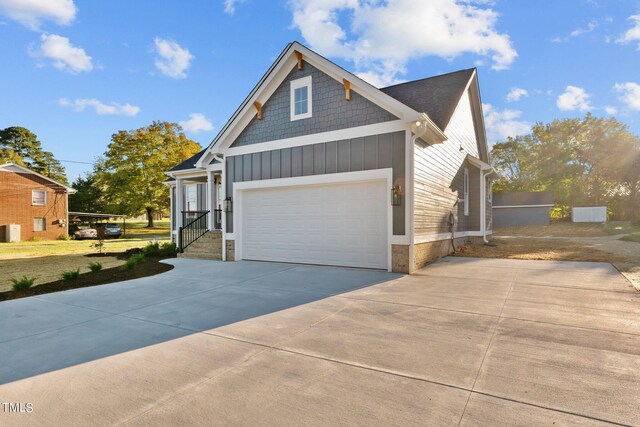 view of front of house with central AC and a garage