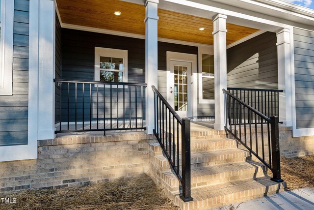 view of exterior entry featuring a porch