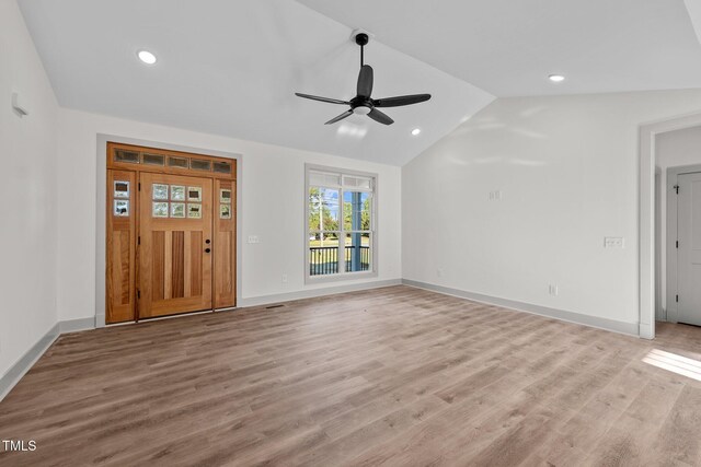 unfurnished living room featuring ceiling fan, light hardwood / wood-style flooring, and vaulted ceiling