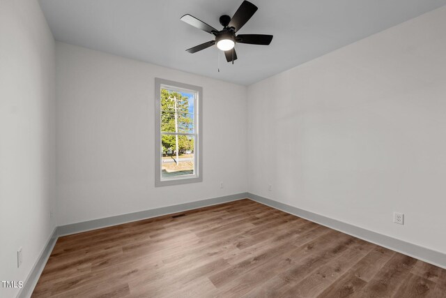 spare room with ceiling fan and light hardwood / wood-style flooring