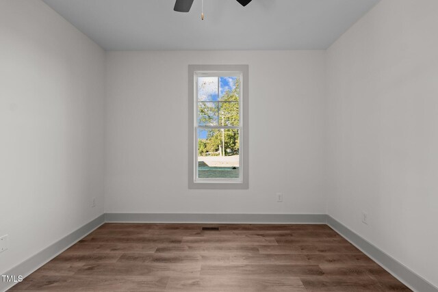 spare room with ceiling fan and hardwood / wood-style flooring