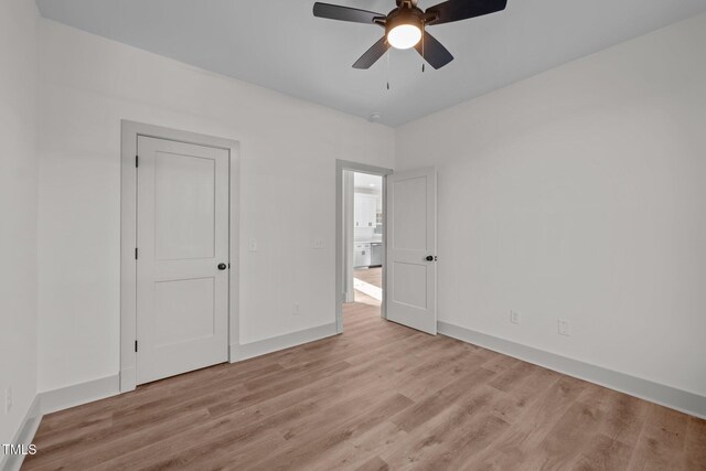 unfurnished bedroom featuring light hardwood / wood-style flooring and ceiling fan