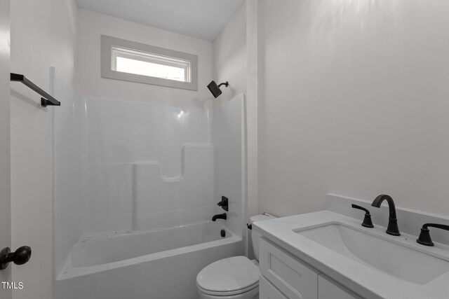 full bathroom featuring washtub / shower combination, vanity, and toilet