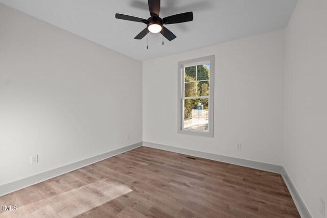 unfurnished room with ceiling fan and hardwood / wood-style floors