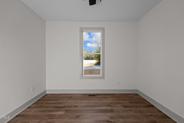 unfurnished room with ceiling fan and dark hardwood / wood-style floors