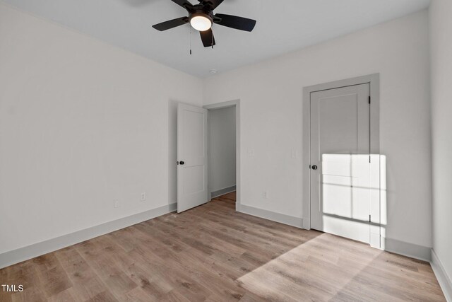 unfurnished room featuring ceiling fan and light wood-type flooring