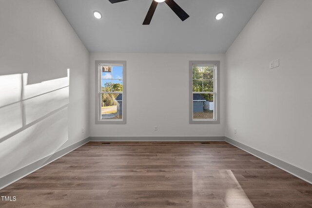 empty room featuring dark hardwood / wood-style flooring, ceiling fan, and lofted ceiling