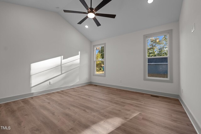 unfurnished room with light wood-type flooring, ceiling fan, and lofted ceiling