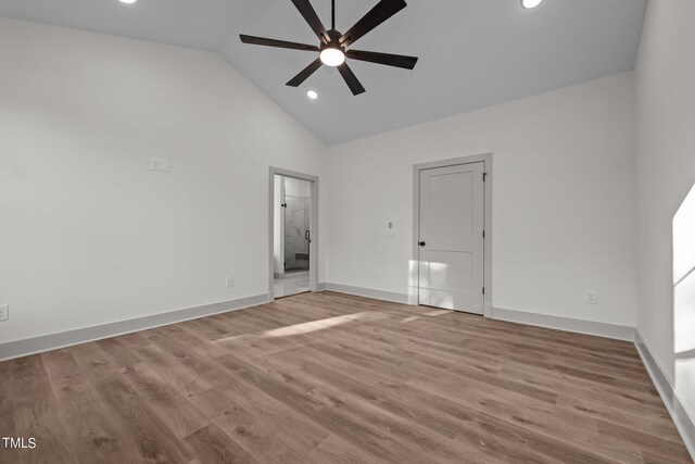 unfurnished bedroom featuring ensuite bath, ceiling fan, high vaulted ceiling, and light wood-type flooring