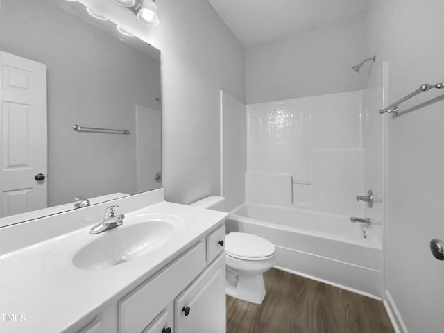 full bathroom featuring hardwood / wood-style floors, vanity, toilet, and shower / washtub combination