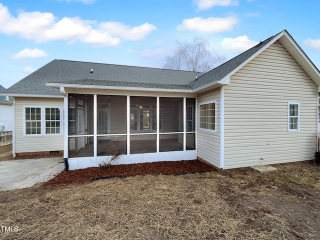 rear view of house with a sunroom and a patio