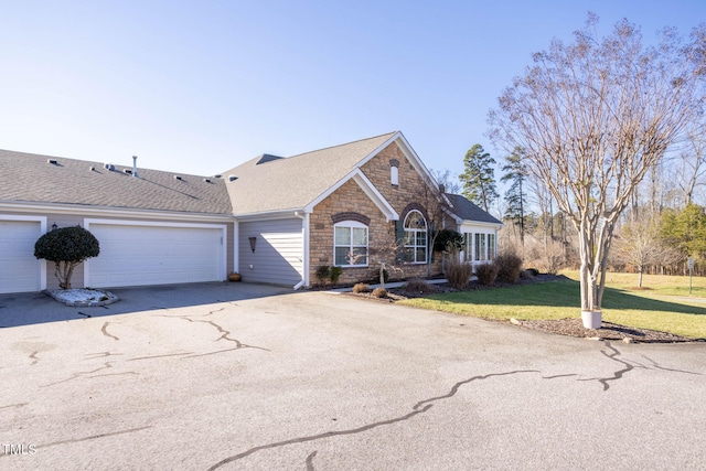 view of front of home with a front yard and a garage